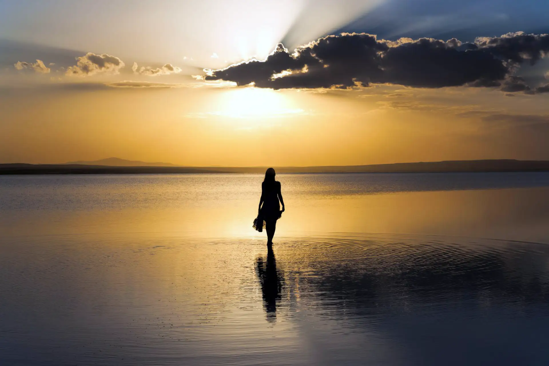Final expenses - lady on the beach at sunset
