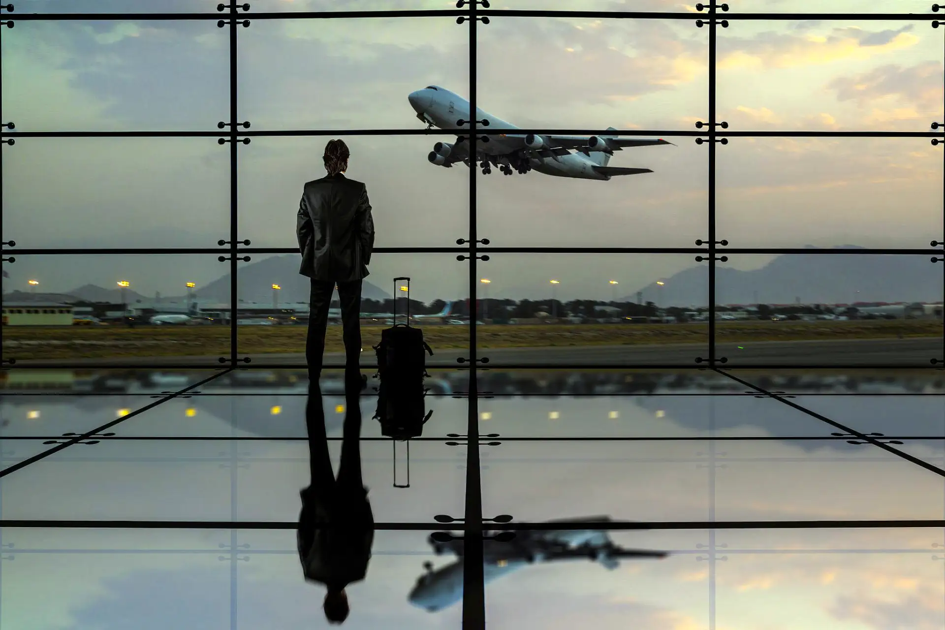 Travel Assistance man looking out the window in airport
