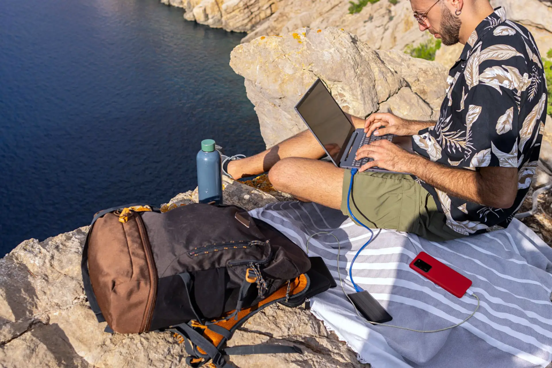 Travel Assistance man working in laptop outdoors